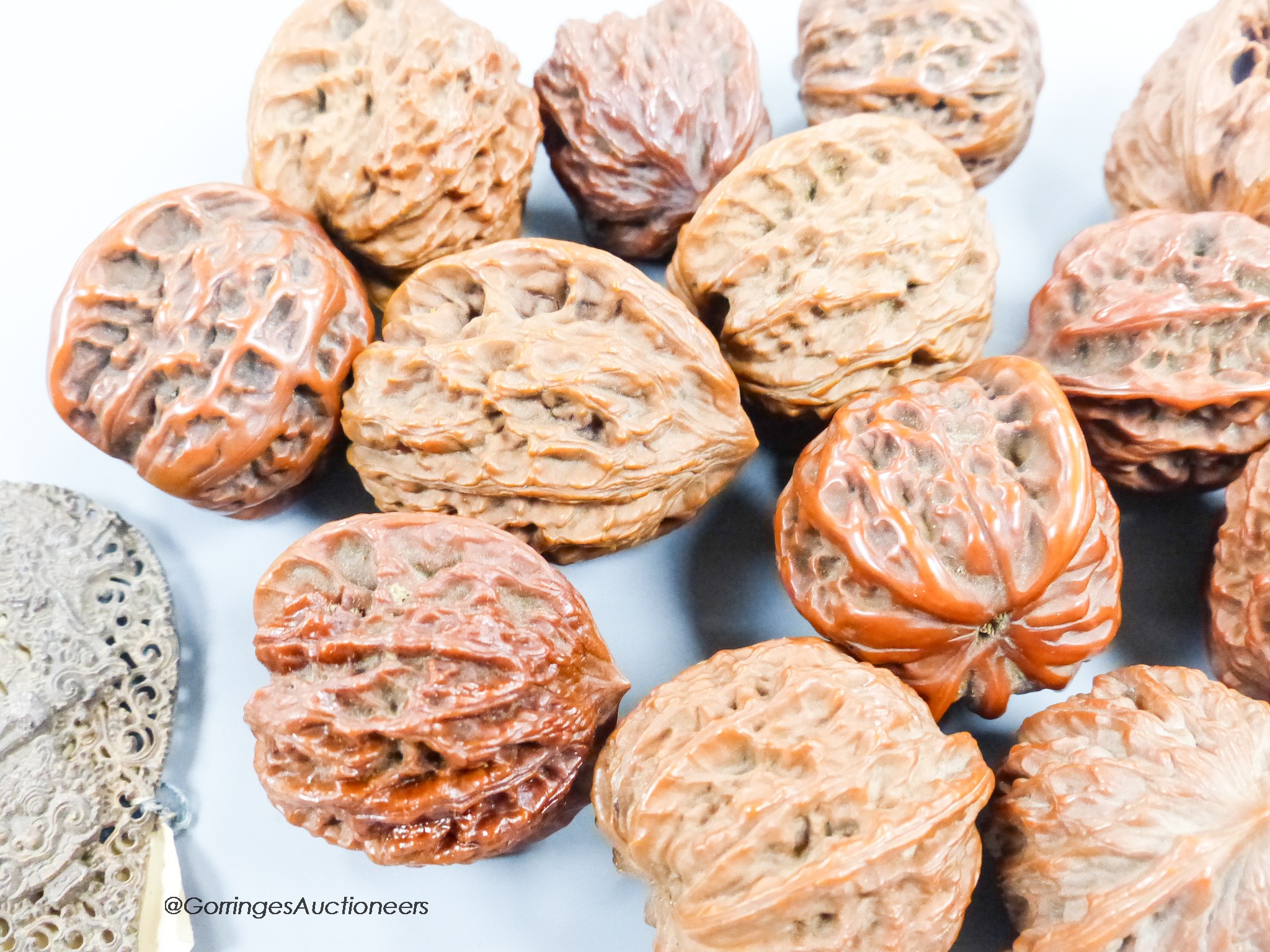 A quantity of walnuts and a Balinese coconut shell heart shaped panel